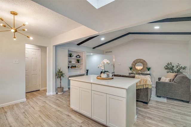 409 Brookview Dr, Garland, TX 75043 - kitchen with light wood-style flooring, light countertops, a kitchen island, white cabinetry, and recessed lighting
