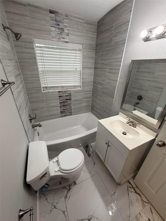 2110 W Bond St, Denison, TX 75020 - bathroom featuring vanity, tub / shower combination, and marble look tiles