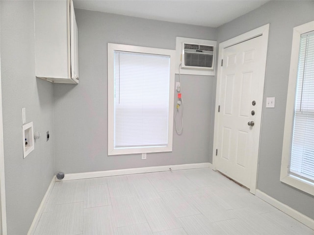 2110 W Bond St, Denison, TX 75020 - laundry room with cabinet space, washer hookup, a wall mounted AC, and electric dryer hookup