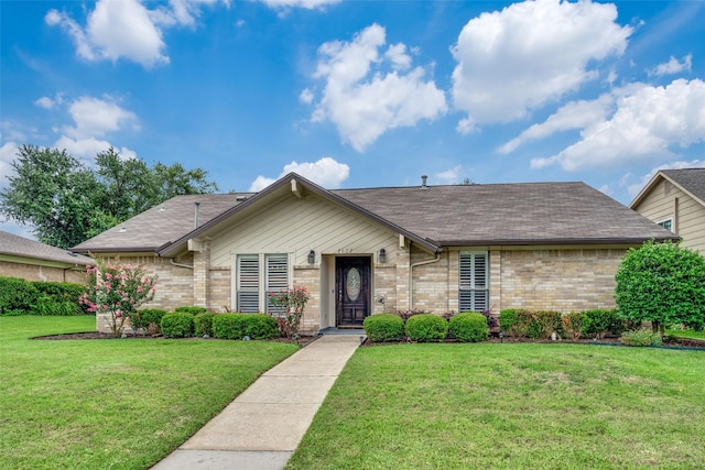 2622 Fallcreek Dr, Carrollton, TX 75006 - view of front of property with brick siding, a front lawn, and a shingled roof