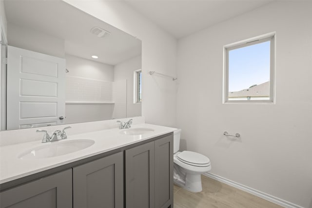 733 Stone Eagle Dr, Azle, TX 76020 - full bath with plenty of natural light, double vanity, and wood finished floors
