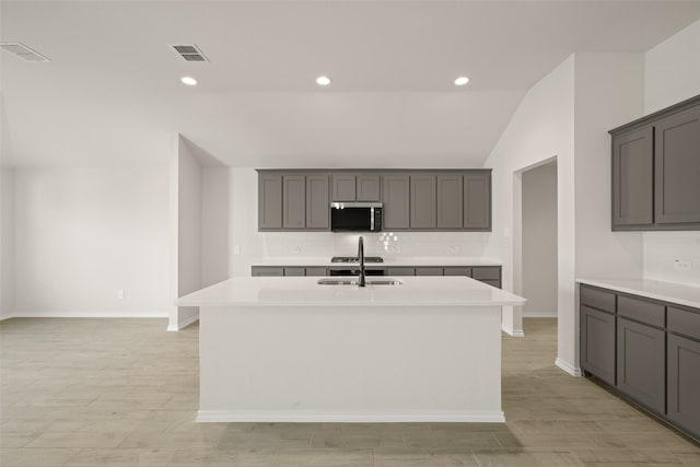733 Stone Eagle Dr, Azle, TX 76020 - kitchen featuring stainless steel microwave, decorative backsplash, vaulted ceiling, light wood-style flooring, and light countertops