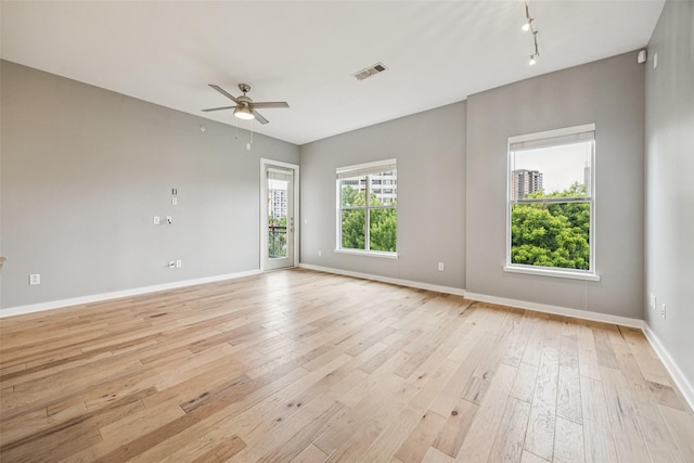 2950 Mckinney Ave Unit 419, Dallas, TX 75204 - unfurnished room with ceiling fan, light wood-style floors, and track lighting