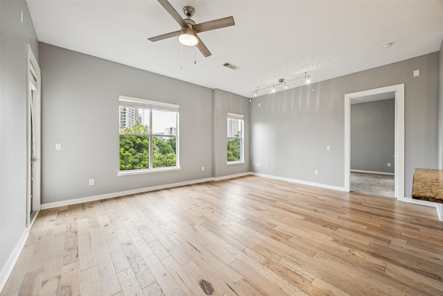 2950 Mckinney Ave Unit 419, Dallas, TX 75204 - kitchen featuring stainless steel appliances, dark brown cabinets, wood finished floors, light stone counters, and backsplash