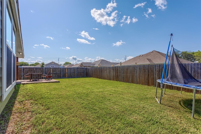 111 Arrowhead Dr, Sanger, TX 76266 - fenced backyard featuring a trampoline and a patio