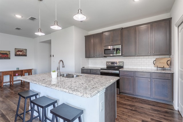 111 Arrowhead Dr, Sanger, TX 76266 - kitchen featuring appliances with stainless steel finishes, dark wood-type flooring, and dark brown cabinets