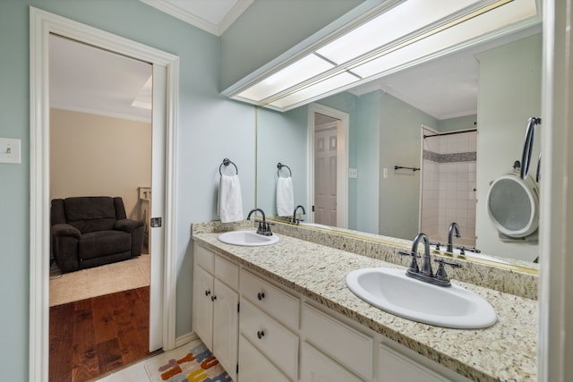 3217 Oak Tree Ln, Grapevine, TX 76051 - bathroom featuring double vanity, ornamental molding, and wood finished floors