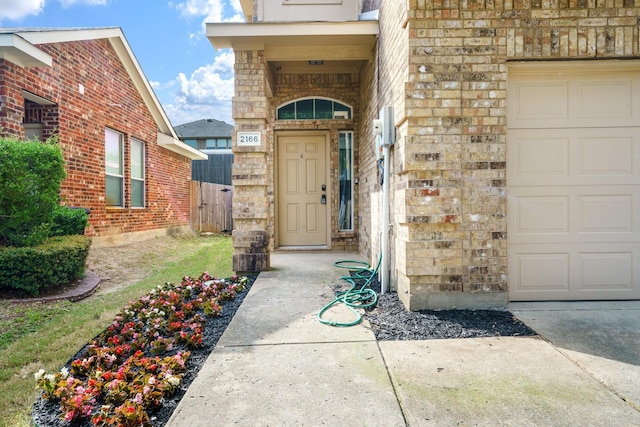 2166 Stonebrook Ln, Mesquite, TX 75181 - view of exterior entry featuring a garage, stone siding, and brick siding