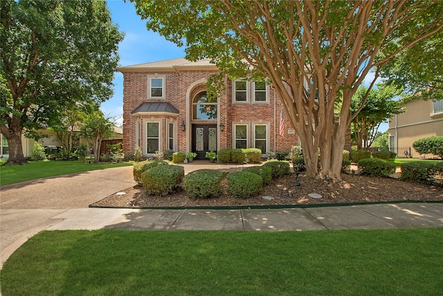 2327 Clearspring Dr N, Irving, TX 75063 - traditional-style home featuring brick siding and a front lawn