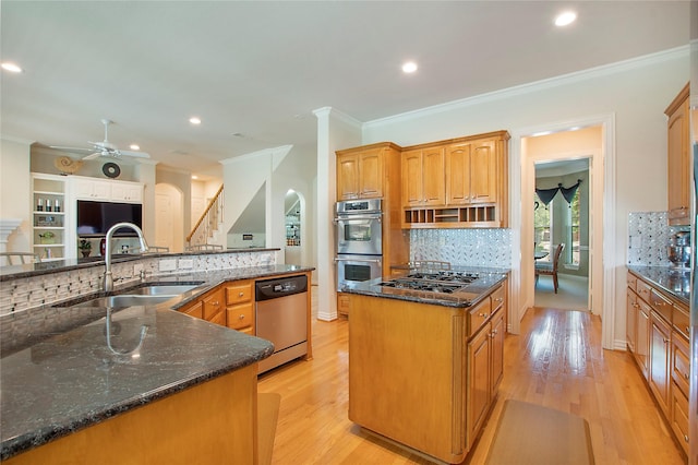 2327 Clearspring Dr N, Irving, TX 75063 - kitchen with appliances with stainless steel finishes, backsplash, dark stone counters, light wood-type flooring, and ornamental molding