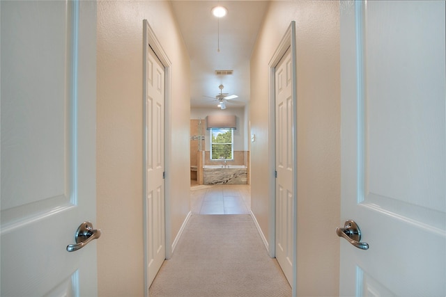 2327 Clearspring Dr N, Irving, TX 75063 - hall featuring light colored carpet and light tile patterned flooring