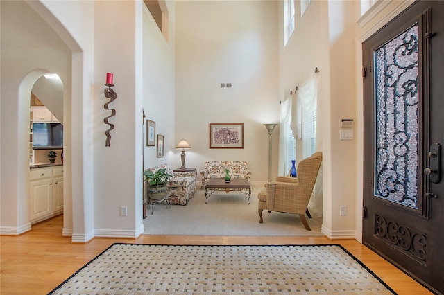 2327 Clearspring Dr N, Irving, TX 75063 - foyer featuring a towering ceiling, light wood-type flooring, and arched walkways