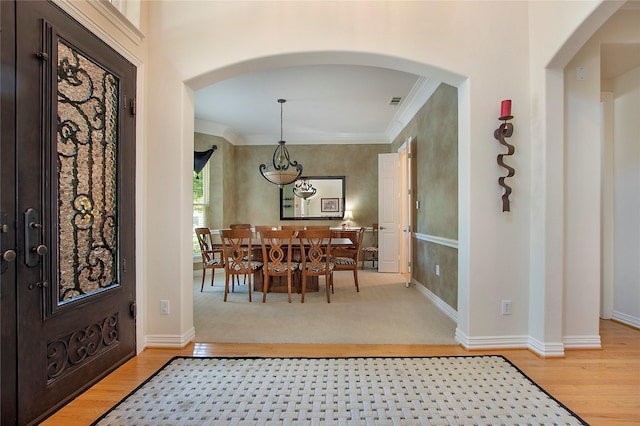 2327 Clearspring Dr N, Irving, TX 75063 - entryway with arched walkways, light wood-type flooring, and ornamental molding