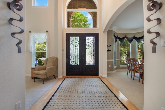 2327 Clearspring Dr N, Irving, TX 75063 - entryway featuring arched walkways, french doors, a towering ceiling, and crown molding