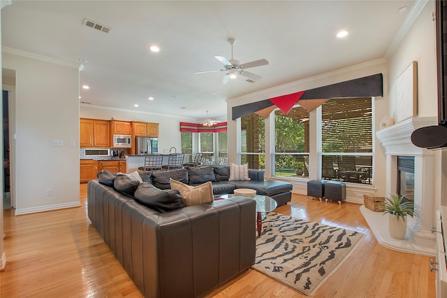 2327 Clearspring Dr N, Irving, TX 75063 - living area with ornamental molding, ceiling fan, light wood-type flooring, and recessed lighting