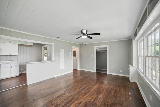 208 Grace Ln, Terrell, TX 75160 - unfurnished living room featuring ornamental molding, a ceiling fan, healthy amount of natural light, and dark wood-type flooring