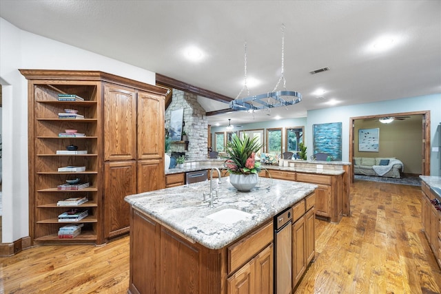 2702 Hidden Trails Rd, Royse City, TX 75189 - kitchen featuring open shelves, light wood-style floors, a kitchen island with sink, and brown cabinetry