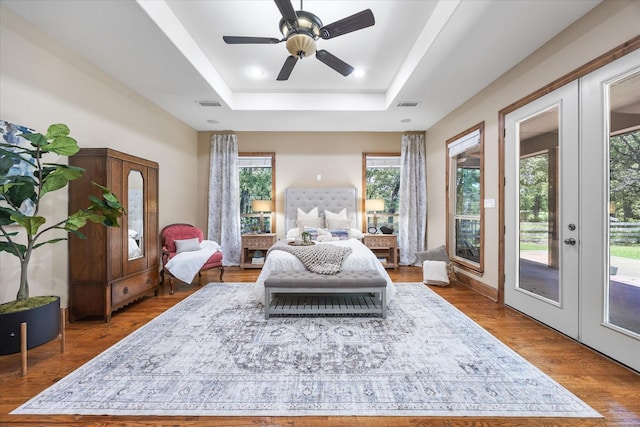 2702 Hidden Trails Rd, Royse City, TX 75189 - bedroom featuring access to exterior, a raised ceiling, wood finished floors, and a ceiling fan