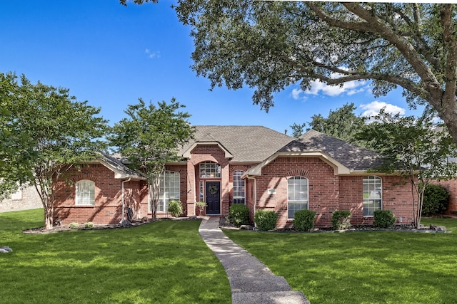 8601 Prescott Cir, Frisco, TX 75034 - view of front facade with a front lawn, brick siding, and a shingled roof