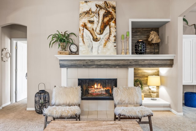 8601 Prescott Cir, Frisco, TX 75034 - sitting room with carpet flooring, arched walkways, and a tile fireplace