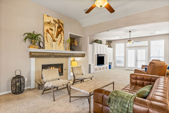 8601 Prescott Cir, Frisco, TX 75034 - living room with a ceiling fan, light colored carpet, a tiled fireplace, and lofted ceiling
