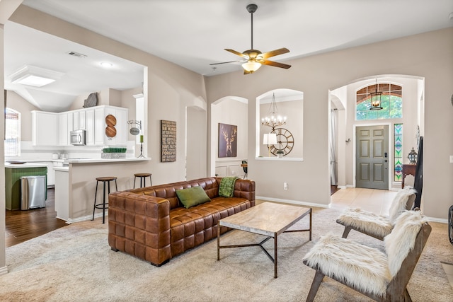 8601 Prescott Cir, Frisco, TX 75034 - living area with arched walkways, plenty of natural light, ceiling fan, and light colored carpet