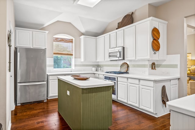 8601 Prescott Cir, Frisco, TX 75034 - kitchen with appliances with stainless steel finishes, dark wood finished floors, white cabinets, light countertops, and lofted ceiling