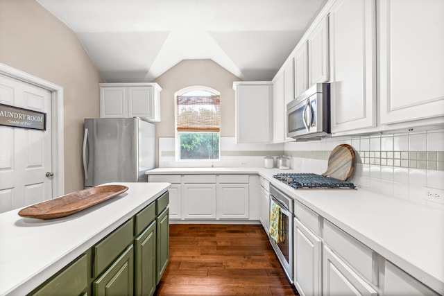 8601 Prescott Cir, Frisco, TX 75034 - kitchen with stainless steel appliances, green cabinetry, white cabinetry, lofted ceiling, and light countertops