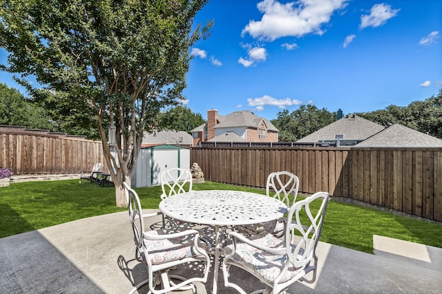 8601 Prescott Cir, Frisco, TX 75034 - fenced backyard with a storage unit, a patio, and outdoor dining space