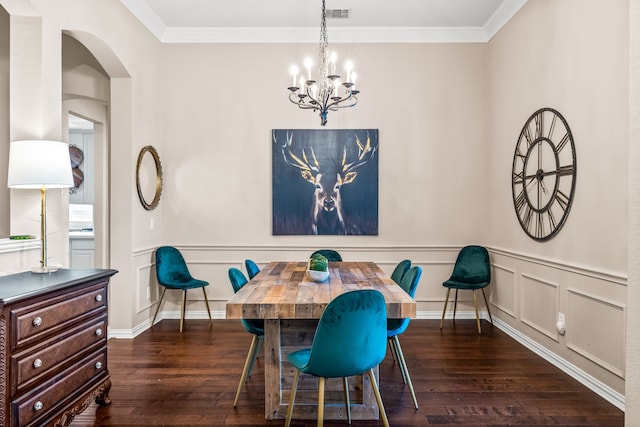8601 Prescott Cir, Frisco, TX 75034 - dining room featuring hardwood / wood-style flooring, a chandelier, arched walkways, crown molding, and a wainscoted wall