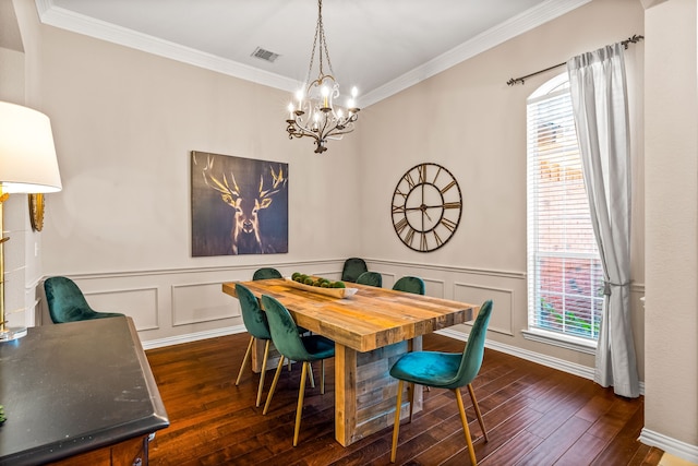 8601 Prescott Cir, Frisco, TX 75034 - dining area with a chandelier, dark wood-style floors, crown molding, a decorative wall, and wainscoting