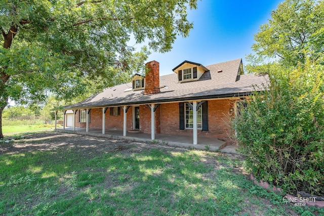 3741 Caldwell Rd, Abilene, TX 79601 - rear view of house featuring a chimney, brick siding, a lawn, and a patio area