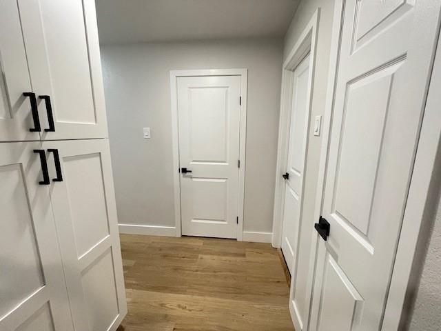 1109 Knotty Oaks Dr, Woodway, TX 76712 - corridor featuring light wood-type flooring and baseboards