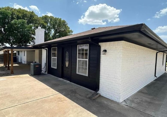 1109 Knotty Oaks Dr, Woodway, TX 76712 - view of home's exterior featuring a chimney, a patio, and brick siding