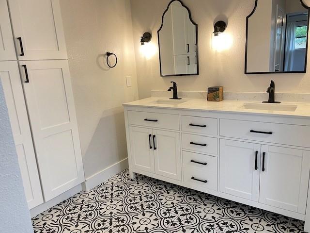 1109 Knotty Oaks Dr, Woodway, TX 76712 - bathroom with double vanity and tile patterned flooring