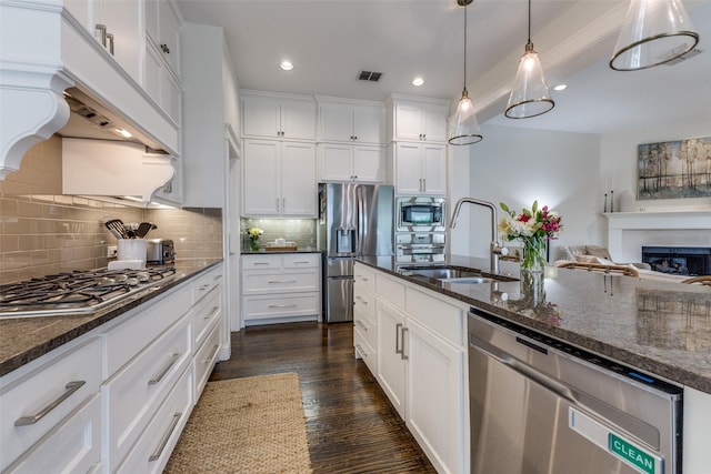 7204 Ripley St, Mckinney, TX 75071 - kitchen with stainless steel appliances, custom range hood, open floor plan, recessed lighting, and white cabinetry