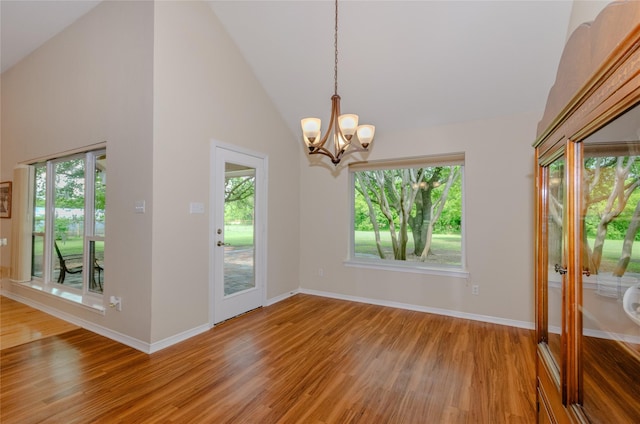 4720 Ashley Cir, Midlothian, TX 76065 - unfurnished room with light wood-type flooring, plenty of natural light, a chandelier, and high vaulted ceiling
