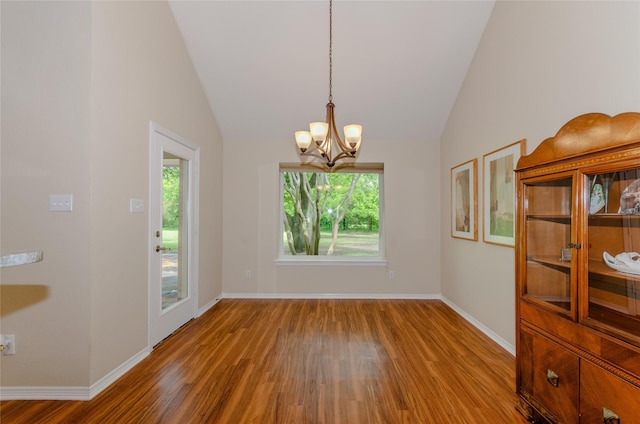 4720 Ashley Cir, Midlothian, TX 76065 - unfurnished dining area with wood finished floors, healthy amount of natural light, a chandelier, and lofted ceiling