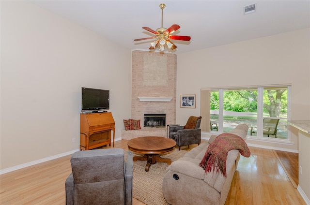4720 Ashley Cir, Midlothian, TX 76065 - living area with light wood-type flooring, a fireplace, and ceiling fan