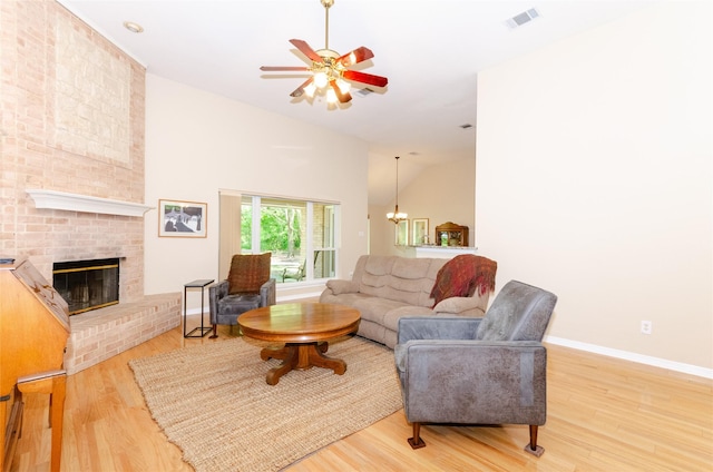 4720 Ashley Cir, Midlothian, TX 76065 - living area with wood finished floors, ceiling fan, a brick fireplace, and high vaulted ceiling