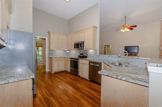 4720 Ashley Cir, Midlothian, TX 76065 - kitchen featuring appliances with stainless steel finishes, dark wood-type flooring, a ceiling fan, backsplash, and light stone counters