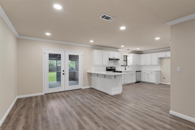 402 2nd St, Moody, TX 76557 - kitchen featuring range, a peninsula, ornamental molding, french doors, and under cabinet range hood