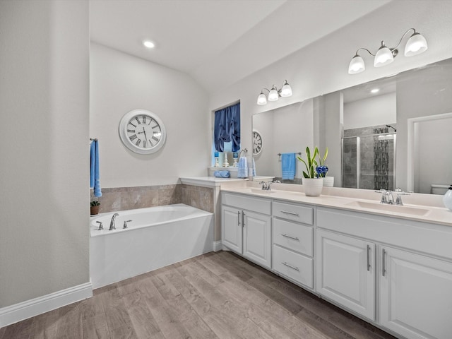 5622 Log Cabin Ct, Midlothian, TX 76065 - bathroom featuring double vanity, a shower stall, a garden tub, wood finished floors, and lofted ceiling