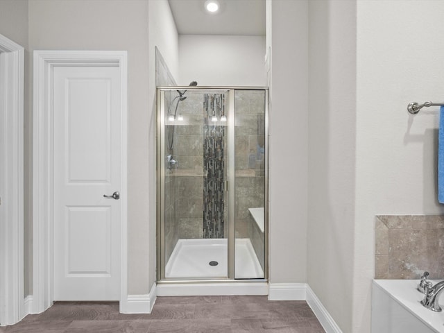 5622 Log Cabin Ct, Midlothian, TX 76065 - bathroom featuring a stall shower, a bath, and wood finished floors