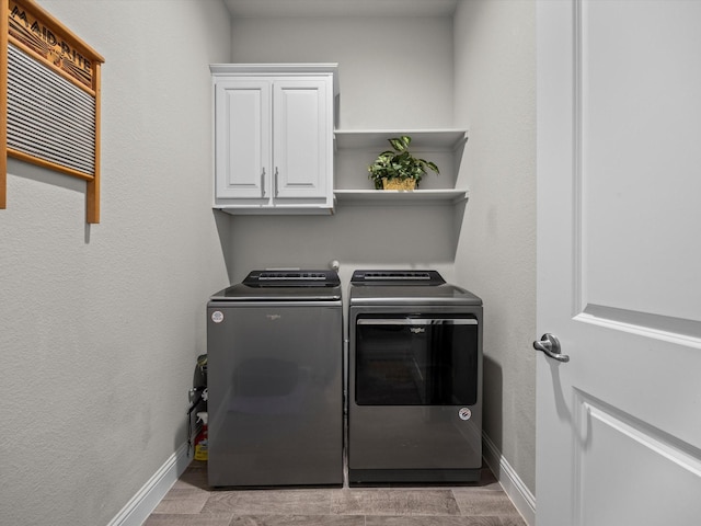 5622 Log Cabin Ct, Midlothian, TX 76065 - washroom with washing machine and dryer, cabinet space, and wood finished floors