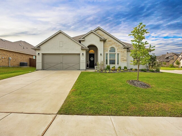 5622 Log Cabin Ct, Midlothian, TX 76065 - view of front of property with a garage, concrete driveway, a front lawn, and stone siding