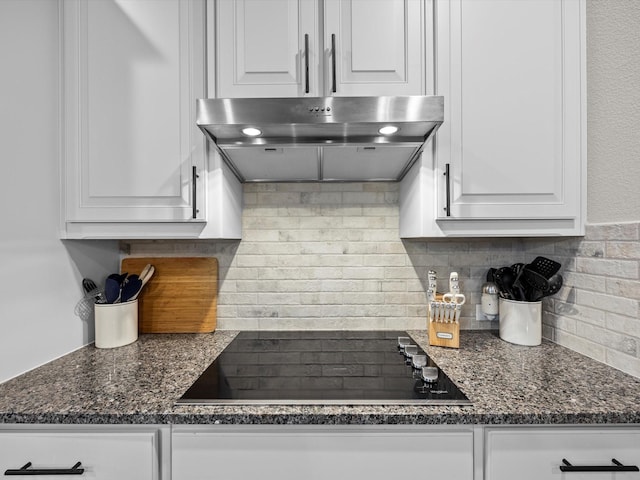 5622 Log Cabin Ct, Midlothian, TX 76065 - kitchen featuring extractor fan, black electric stovetop, white cabinets, and tasteful backsplash
