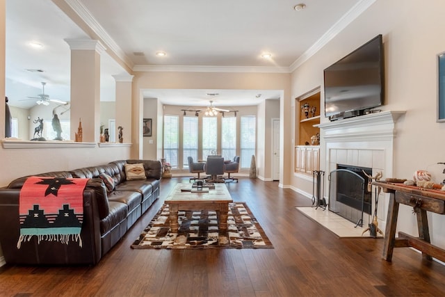 1023 Muirfield Dr, Mansfield, TX 76063 - living area featuring wood finished floors, crown molding, ceiling fan, a tile fireplace, and a chandelier