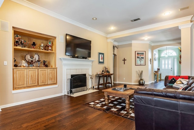 1023 Muirfield Dr, Mansfield, TX 76063 - living area with arched walkways, dark wood-type flooring, ornamental molding, and a fireplace