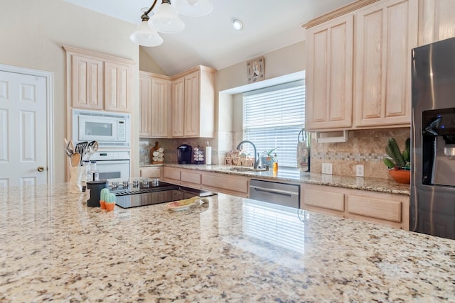 1023 Muirfield Dr, Mansfield, TX 76063 - kitchen with stainless steel appliances, light brown cabinetry, tasteful backsplash, light stone countertops, and lofted ceiling